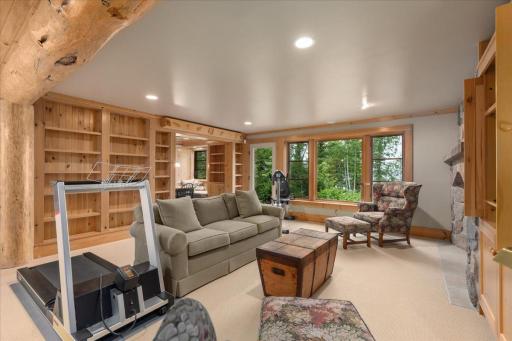 As you walk down the stairs the lower level walk out will greet you and the family room is a perfect entertaining space complete with floor to ceiling book shelves.