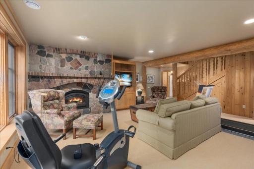 What a special place to enjoy time together and that stone custom fireplace offers the convenience of a gas insert and is a showstopper.