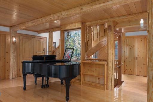 The custom beams are pillars that frame this beautiful space for your piano or a special piece of furniture complete with bookshelves.