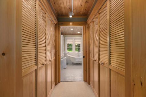 The double sided walk in closet space is fully designed with custom built ins.