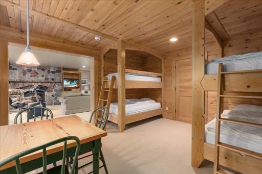 This beautifully crafted bunk room for the kids is encased in wood with custom ladders and every inch of it is pure fabulousness all overlooking the lake!