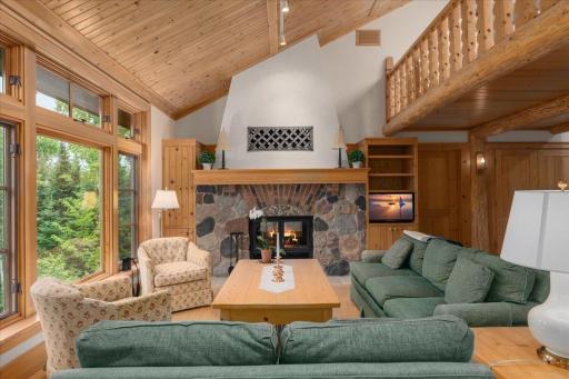 The gorgeous vaulted slat ceilings rise to the loft connecting this incredible space.