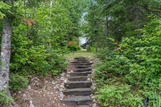 A granite stone path is a perfect entrance from the lake to the house.