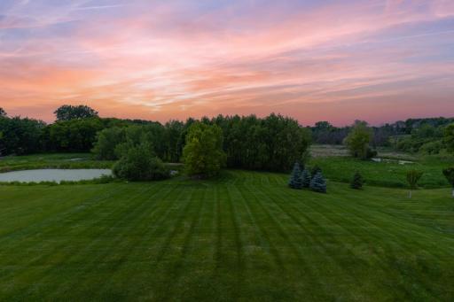 Professionally landscaped grounds with mature trees and seasonal blooms