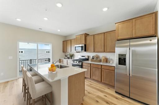 Warm and inviting! The kitchen has timeless finishes that blend an elevated feel with functionality.