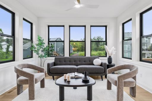 Your four season sunroom extension features large Andersen Fibrex windows and it looks out to a pond!