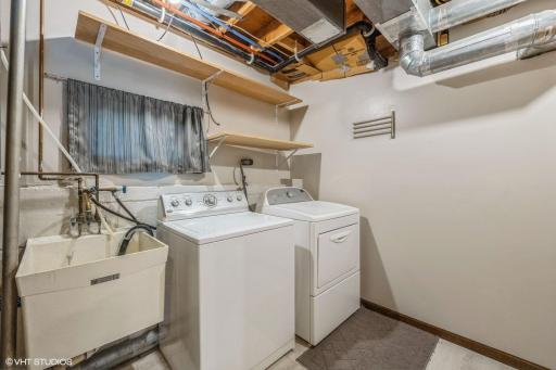 Laundry room is spacious and has a large sink.