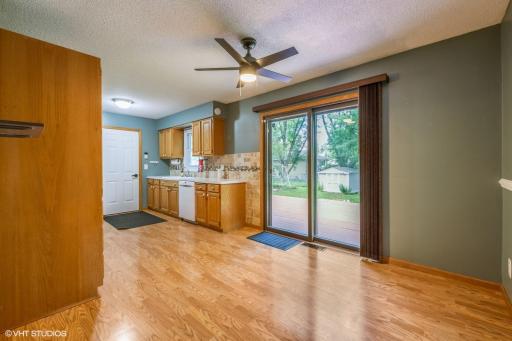Kitchen and dining area. Sliding door leads to deck in back.