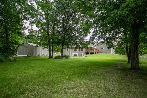 48 Looking from the backyard, you’ll see a spacious deck perfect for relaxing and entertaining, with the large pole shed nearby offering extra storage and workspace.