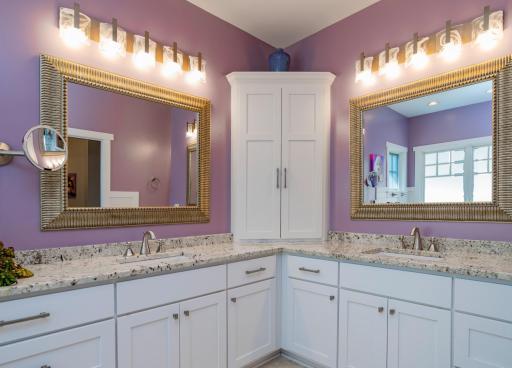 Separate sinks in the primary bathroom. Ideal for two, there are also TWO walk-in closets in this suite!