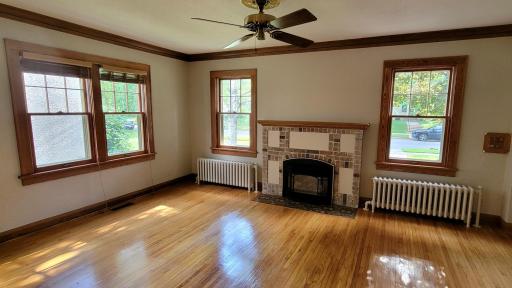 The living room features a brick and stucco fireplace with an oak mantle. It has a convenient gas insert for instant mood setting and added warmth.