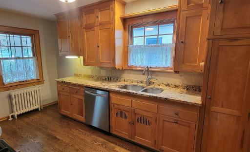 Updated kitchen that incorporated the original cabinets and added new floors, granite counter tops with a convenient undermount sink.