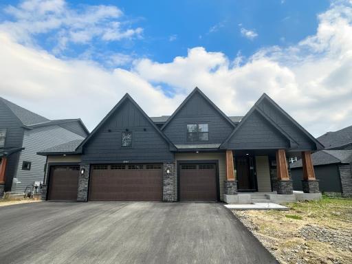 Photo of the actual home. Excellent curb appeal on the Carmel floorplan! This home boasts 6 beds and 5 baths and a 4-car garage.