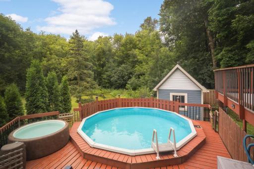 Outdoor pool is surrounded by a beautiful lush tree-lined back yard. ***Pool will be removed 9/6/25 so if interested in enjoying this next summer schedule a showing ASAP.*