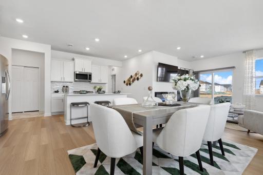 (Photo of decorated model, actual homes colors and finishes will vary) This spacious and open main level seamlessly connects to the kitchen area, perfect for entertaining.