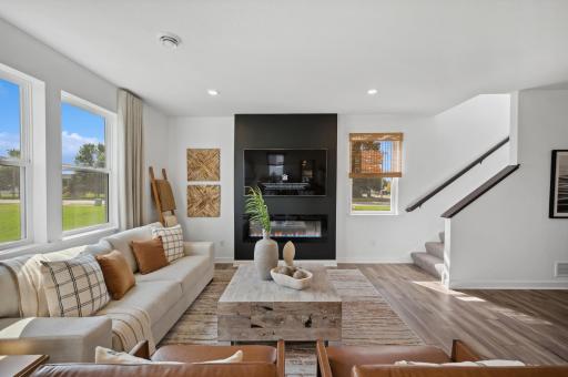 (Photo of decorated model, actual homes color and finishes will vary)This spacious family gathering area seamlessly connects to the kitchen and dining areas, perfect for entertaining. It also features many large windows providing warm natural light