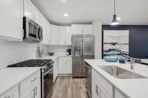 (Photo of a decorated model, actual homes finishes will vary) (Photo of decorated model, actual home's finishes vary) Thoughtfully-designed with a combination of functionality and modern design, this kitchen space is sure to impress.