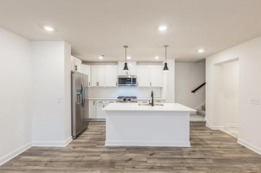 (Photo of similar home, features will vary) Designed for adventurous cooks, the kitchen comes well-equipped with popular features like high-end appliances and a center island that doubles as a breakfast bar.