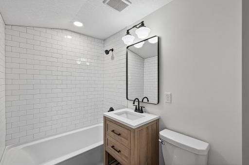 From the tiled main floor bath to the stylish upstairs and lower level baths, each space is thoughtfully designed with fresh vanities, tile work, and updated plumbing.