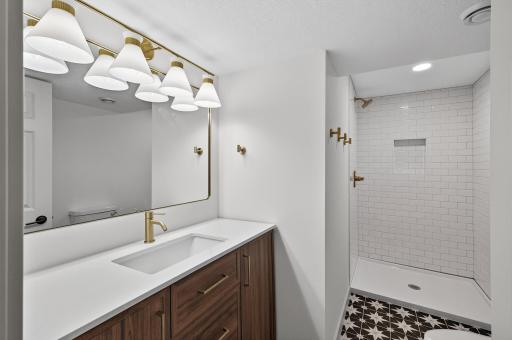 Designer lower level tiled 3/4 bath. This home is a top-to-bottom transformation with brand new systems, finishes, and layout enhancements that make this a true turn-key home.