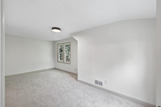 New flooring and fresh paint continues into the bright upper level 3rd bedroom.