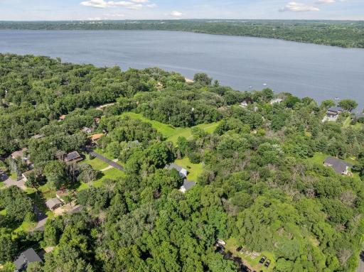 Aerial view of the spacious backyard and the scenic trail that leads directly to the south end of the St. Mary's Point public beach.