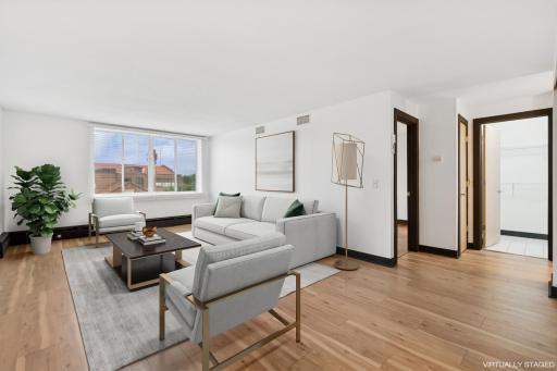 Whether you're entertaining guests or enjoying a quiet night in, this living area offers style, comfort, and endless versatility—with the light-filled bedroom and in-unit laundry conveniently located just off to the side for everyday ease.
