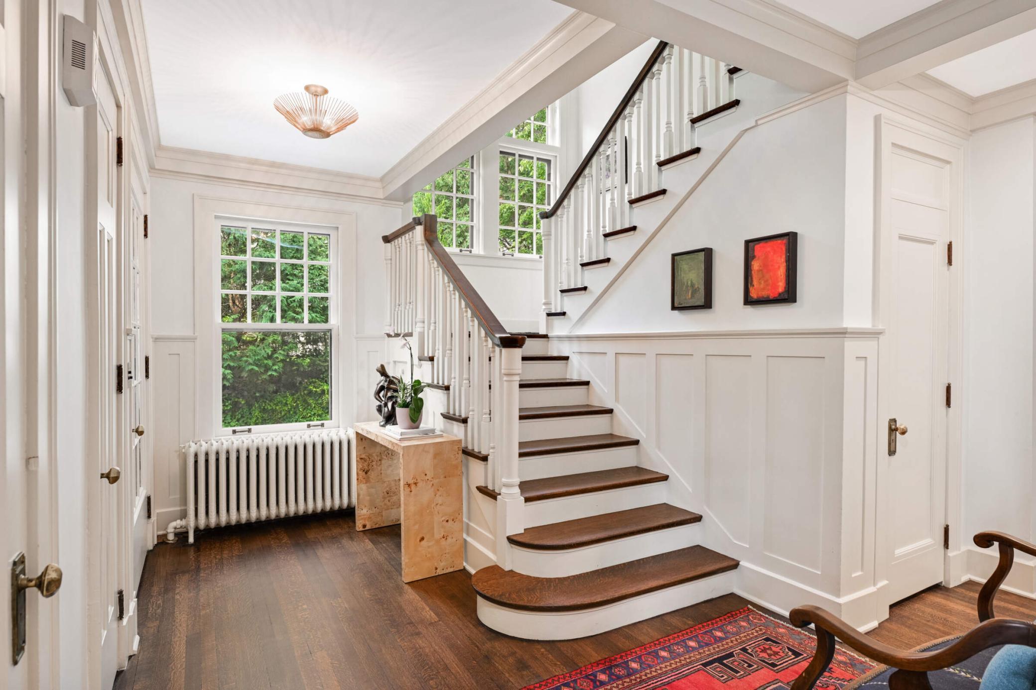Timeless details: Paneled walls, carved newel posts & balusters, and built-in drawers.