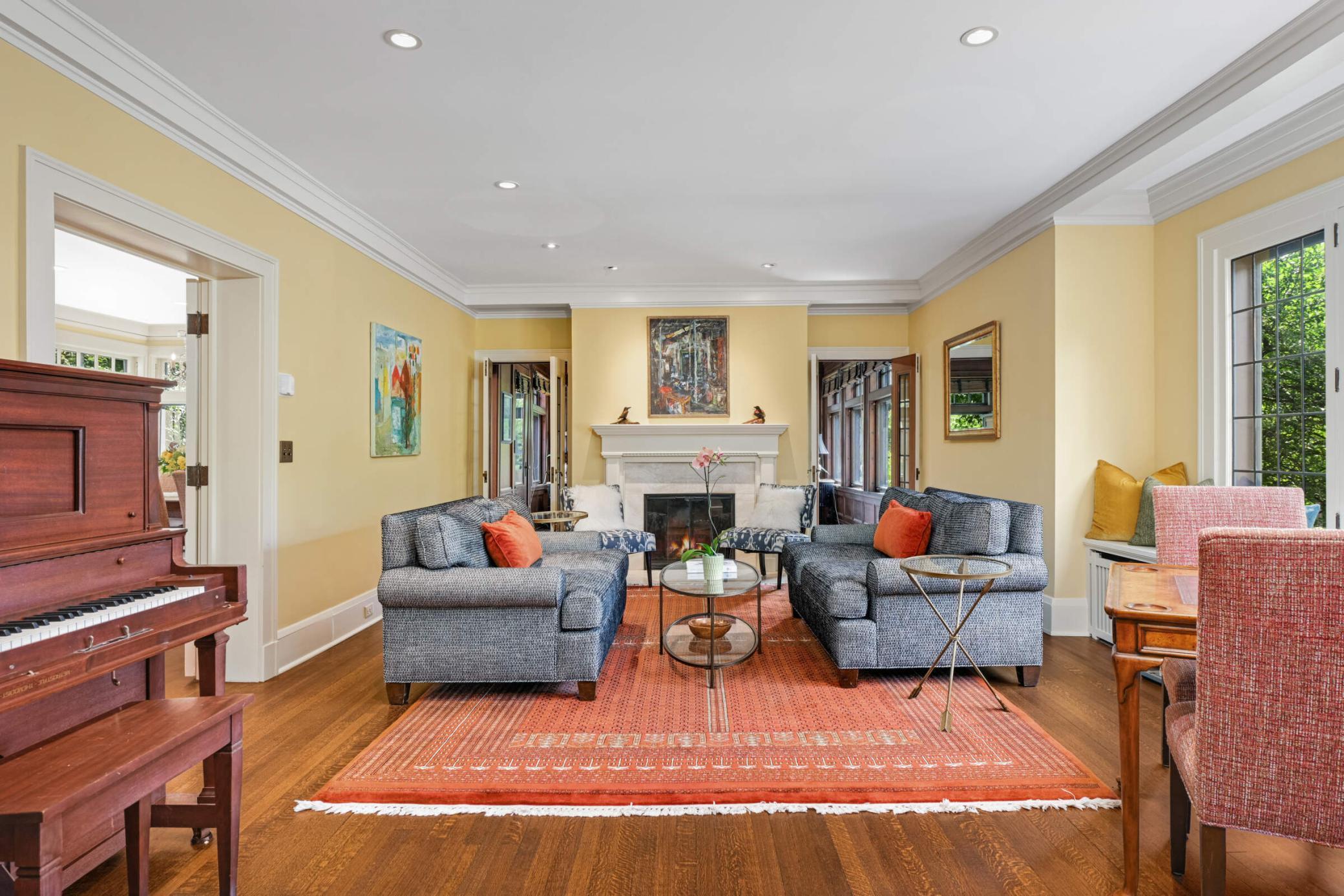 Directly off the foyer is the formal living room with a wood-burning fireplace.