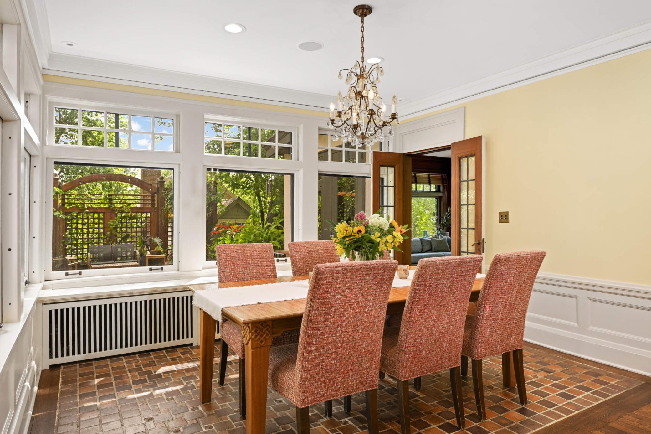 The dining room has the original refurbished clay tiled floors & endless windows!