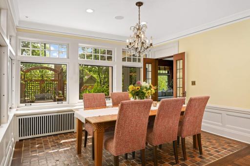 The dining room has the original refurbished clay tiled floors & endless windows!