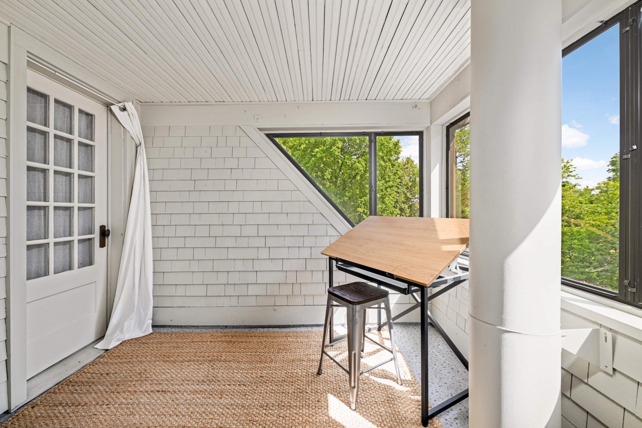 An original "sleeping" porch off bedroom #4 serves as an amazing work-from-home space 6-7 months of the year.