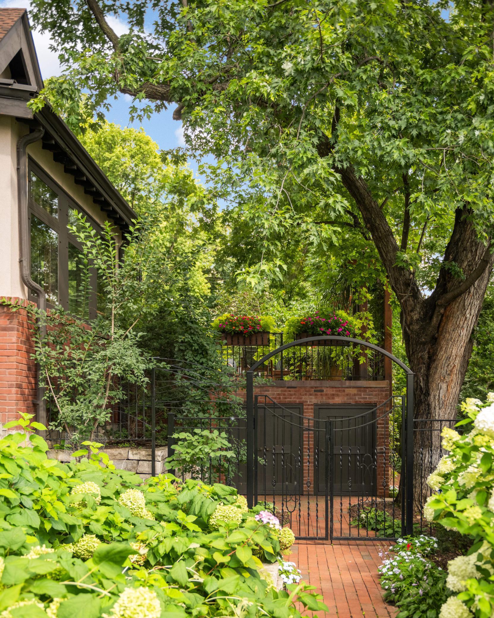 The gate and pathway from the front yard to the shed offers ez access to Lake of Isles' trails.