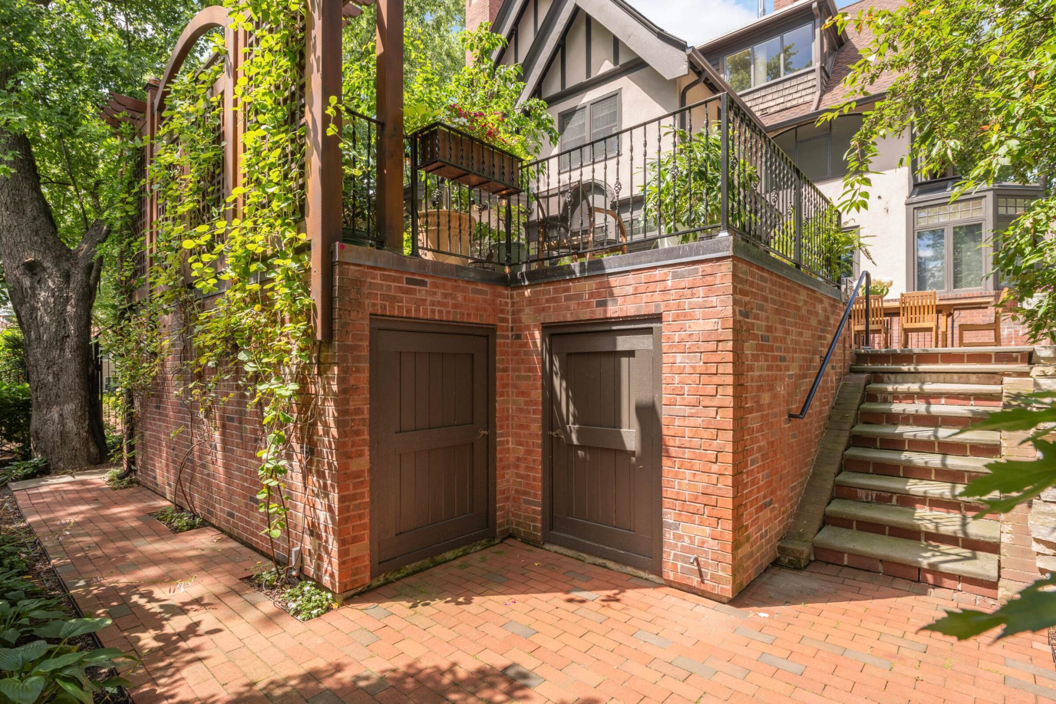 Below the terrace is this brick storage shed for outdoor toys and tools.