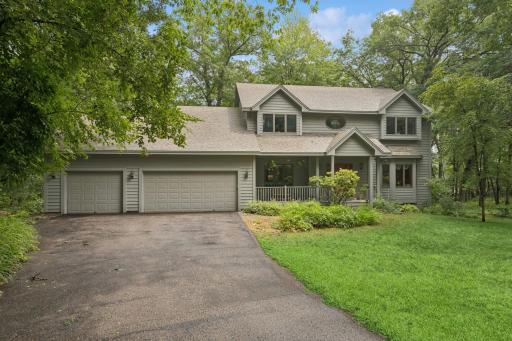 Find serenity in the woods with this Western Cedar-sided walkout two-story home. Other details include: 2 rear decks as well as a front porch offering multiple exterior seating opportunities for enjoying the peaceful surroundings.