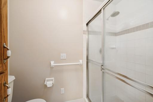 A separate tile shower, corner bench and linen closet offer convenience.