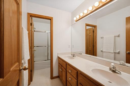 A full upper level bath has dual sinks and a separate water closet. Great for multiple people getting ready for the day ahead.