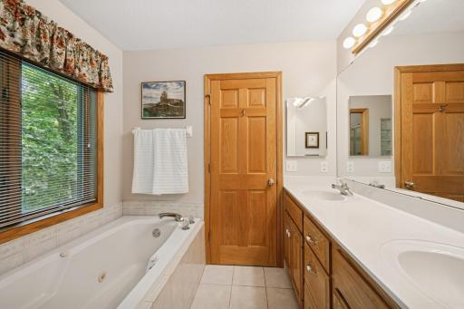 Additional Owner's bathroom angle. Tile floors, & a great wooded view.