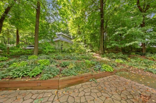 Towering mature trees, and private, fully fenced yard filled with hundreds of custom-planted hostas and perennials.