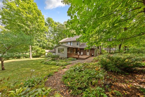 Towering mature trees, and private, fully fenced yard filled with hundreds of custom-planted hostas and perennials.