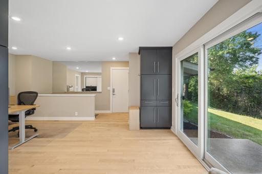 Mudroom space with storage inside the garage service door.