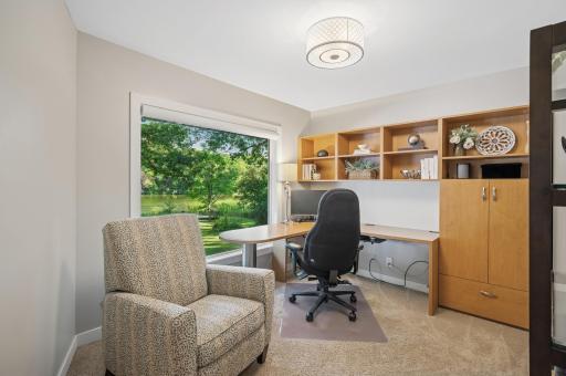 Office with custom built in desk and cabinets.