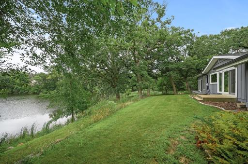 Beautiful green space between the home and the lake.