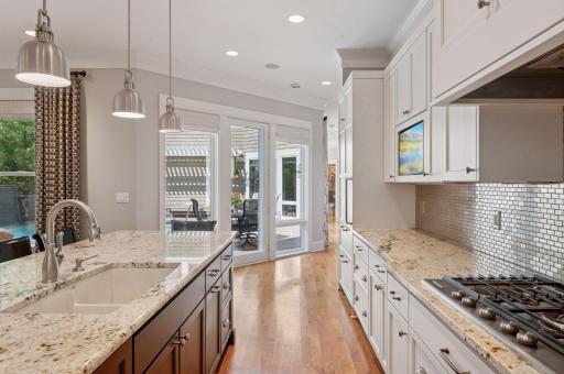 Stunning custom cabinets and large windows with a pool view.