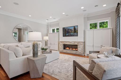 Built-in storage with a Gas-burning stone fireplace.