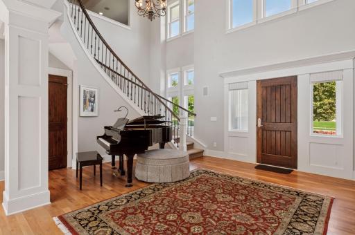 A grand staircase ascends to the second floor.
