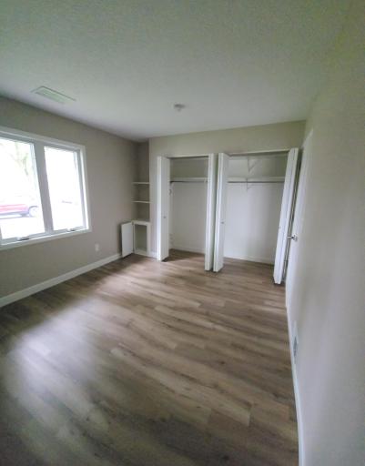 Nice sized bedroom with good sunlight shining in. Large double closet with shelves and small storage drawer