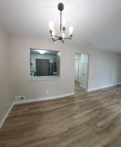Dining area with pass-through opening from the kitchen. All new flooring through-out the home! Beautiful! Very clean!