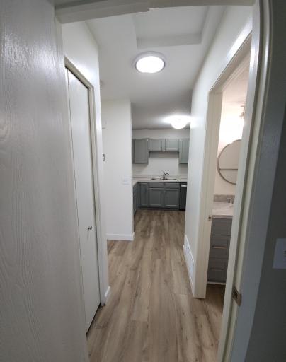 Hallway from bedroom to kitchen. Very nice lighting through-out the home!