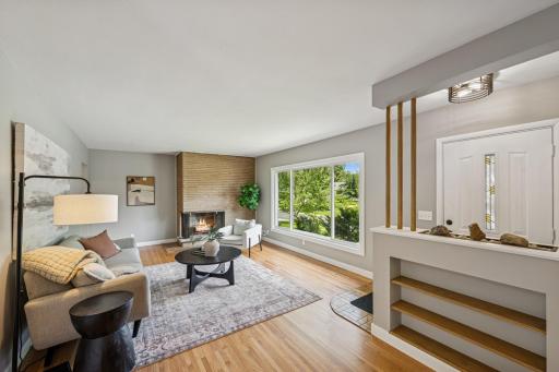 Welcome to 8007 Virginia Cir. Main floor living room with hardwood floors and tons of natural light.jpg